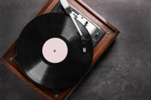 Record player with vinyl disc on grey background Record player with vinyl disc on grey background